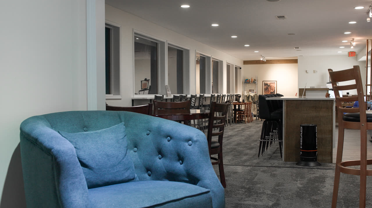 The lounge at Match Point KC, from the armchairs through to the tables and bar seating
