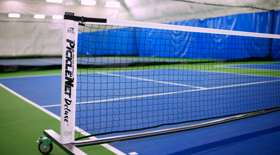 A pickleball net set up on an indoor court at Match Point KC